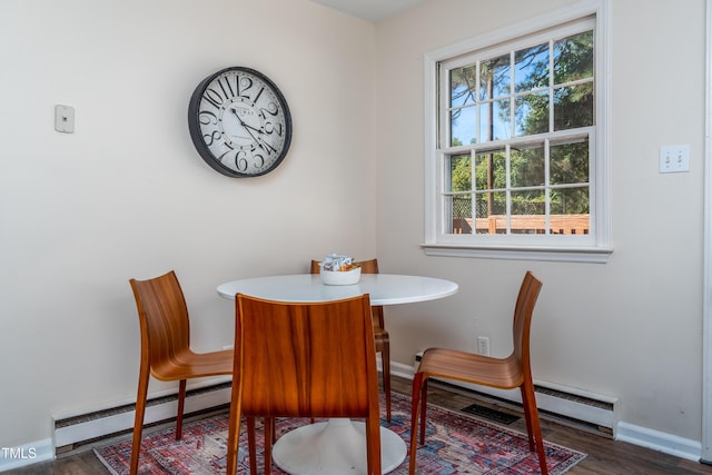 dining area with baseboards, a baseboard radiator, and wood finished floors