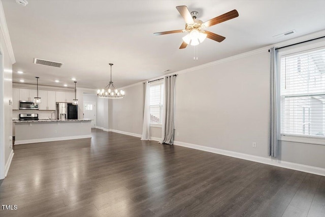 212 Sea Trail St, Hillsborough, NC 27278 - unfurnished living room with crown molding, ceiling fan, dark wood finished floors, plenty of natural light, and a chandelier