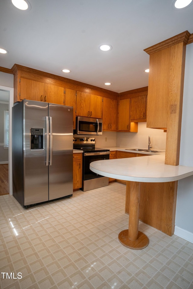 4813 Glen Forest Dr, Raleigh, NC 27612 - kitchen featuring stainless steel appliances, brown cabinetry, light countertops, and recessed lighting