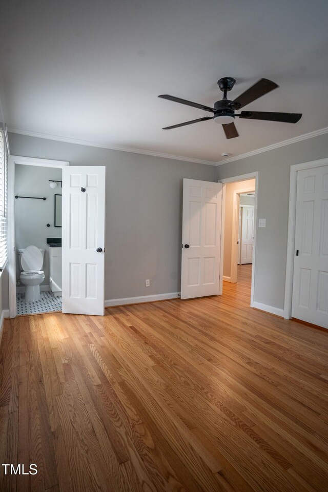 4813 Glen Forest Dr, Raleigh, NC 27612 - unfurnished bedroom with ornamental molding, baseboards, light wood-type flooring, and ensuite bathroom