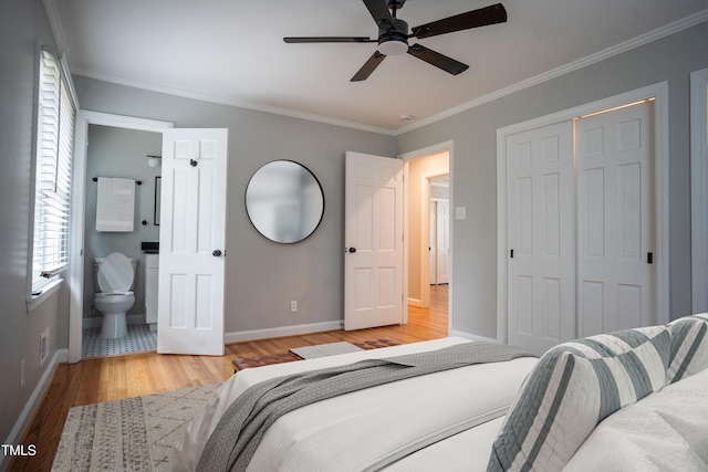 4813 Glen Forest Dr, Raleigh, NC 27612 - bedroom featuring baseboards, crown molding, wood finished floors, a closet, and ensuite bath