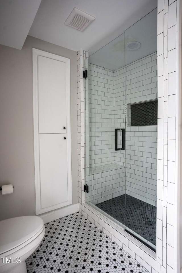 4813 Glen Forest Dr, Raleigh, NC 27612 - bathroom with a stall shower, toilet, and tile patterned floors