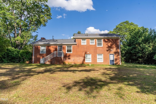 4813 Glen Forest Dr, Raleigh, NC 27612 - back of house with a lawn, brick siding, and a chimney