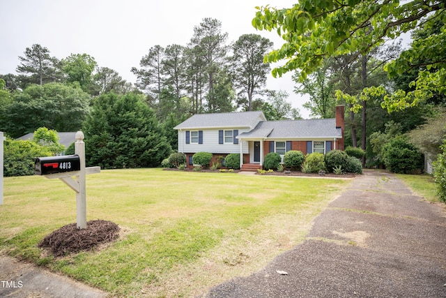 4813 Glen Forest Dr, Raleigh, NC 27612 - tri-level home featuring asphalt driveway, a chimney, a front yard, and brick siding