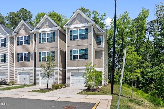 4157 Trevino Dr, Durham, NC 27704 - view of front of house with driveway, an attached garage, and board and batten siding