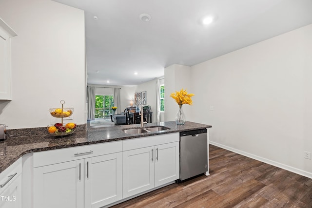 4157 Trevino Dr, Durham, NC 27704 - kitchen featuring dishwasher, dark wood-style flooring, white cabinetry, dark stone counters, and a sink