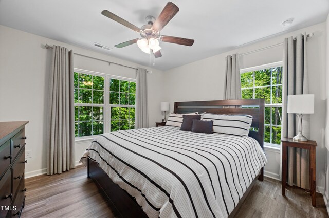 4157 Trevino Dr, Durham, NC 27704 - bedroom featuring wood finished floors, baseboards, and a ceiling fan