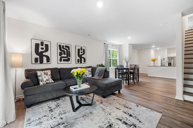 4157 Trevino Dr, Durham, NC 27704 - living area with wood finished floors, recessed lighting, baseboards, and stairway