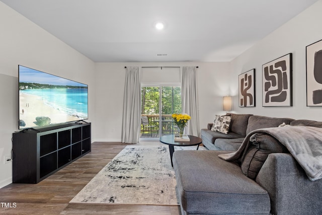 4157 Trevino Dr, Durham, NC 27704 - living room with dark wood finished floors, baseboards, and recessed lighting