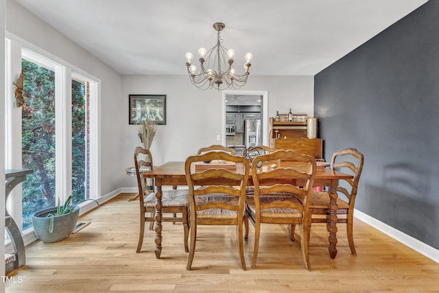 10909 Raven Rock Dr, Raleigh, NC 27614 - dining space featuring a chandelier, light wood-type flooring, and baseboards