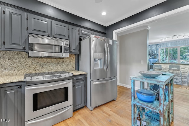 10909 Raven Rock Dr, Raleigh, NC 27614 - kitchen with appliances with stainless steel finishes, gray cabinets, light wood finished floors, decorative backsplash, and baseboards