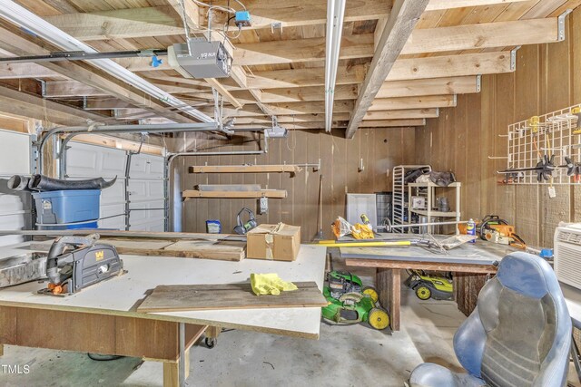 10909 Raven Rock Dr, Raleigh, NC 27614 - garage with a garage door opener, a workshop area, and wood walls