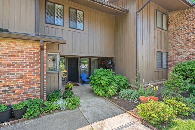 doorway to property with brick siding