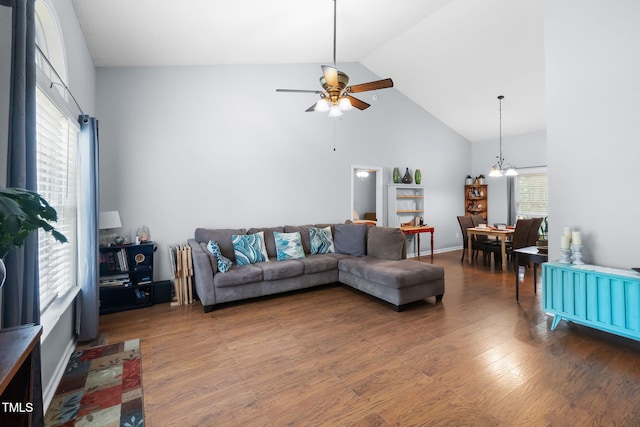 687 W Watson Rd, Benson, NC 27504 - living area with a ceiling fan, wood finished floors, high vaulted ceiling, and a chandelier