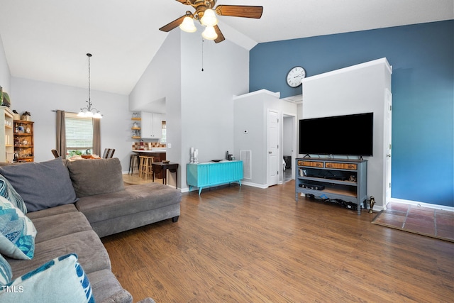 687 W Watson Rd, Benson, NC 27504 - living area featuring ceiling fan, a chandelier, high vaulted ceiling, wood finished floors, and baseboards