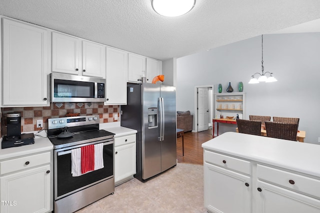 687 W Watson Rd, Benson, NC 27504 - kitchen with stainless steel appliances, white cabinets, light countertops, and a textured ceiling