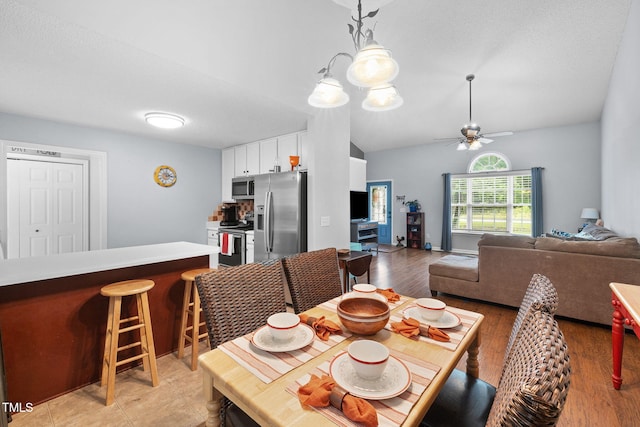687 W Watson Rd, Benson, NC 27504 - dining room with ceiling fan, light wood-style floors, and vaulted ceiling