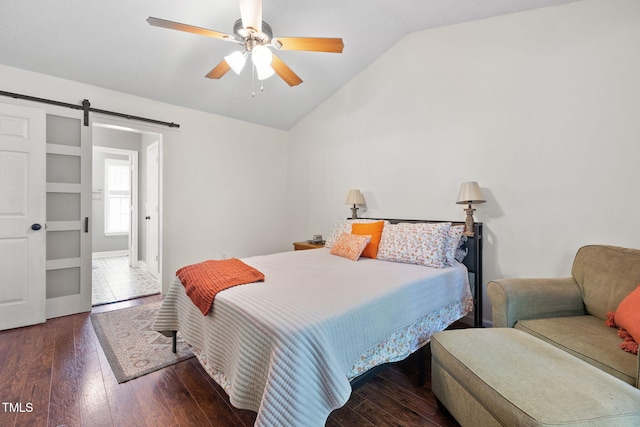 687 W Watson Rd, Benson, NC 27504 - bedroom featuring lofted ceiling, a barn door, wood finished floors, ceiling fan, and baseboards