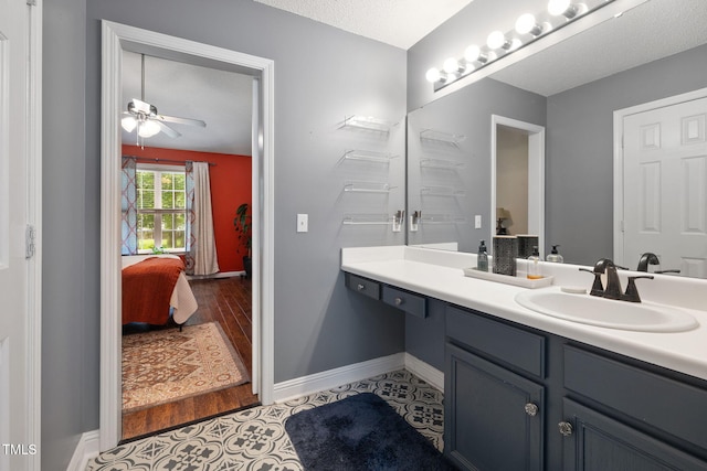 687 W Watson Rd, Benson, NC 27504 - ensuite bathroom featuring vanity, a ceiling fan, baseboards, tile patterned floors, and a textured ceiling