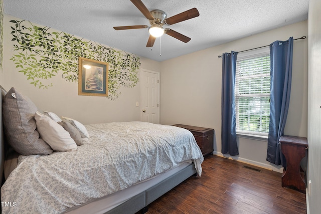 687 W Watson Rd, Benson, NC 27504 - bedroom featuring baseboards, multiple windows, dark wood-type flooring, a textured ceiling, and ceiling fan