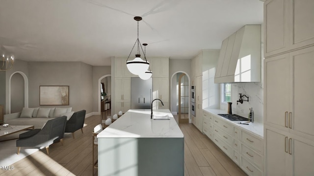 913 Tyrrell Rd, Raleigh, NC 27609 - kitchen featuring arched walkways, a sink, light wood-style flooring, custom exhaust hood, and stainless steel appliances