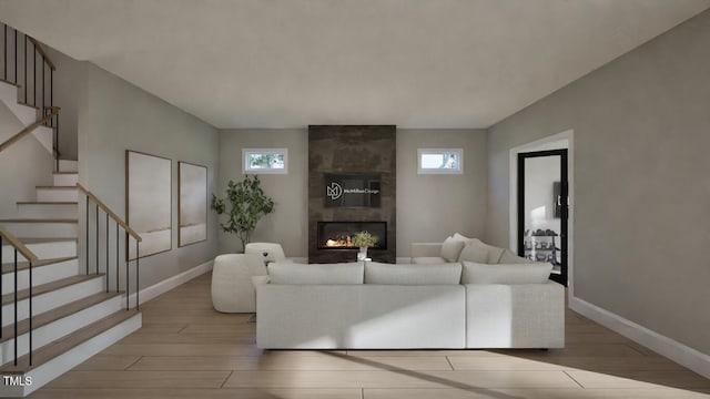 913 Tyrrell Rd, Raleigh, NC 27609 - living room featuring light wood-type flooring, stairs, a fireplace, and baseboards