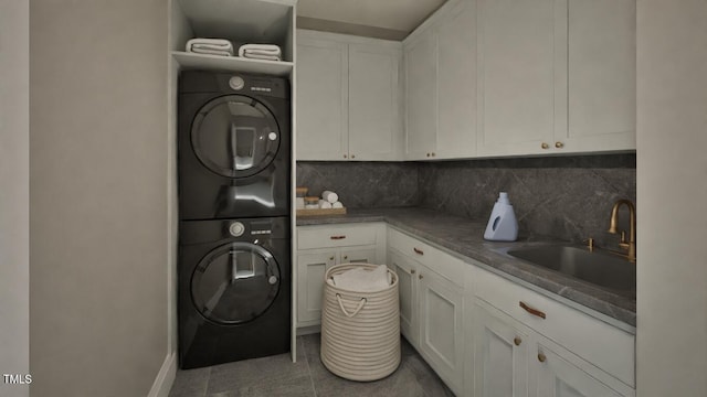 913 Tyrrell Rd, Raleigh, NC 27609 - laundry area featuring cabinet space, stacked washer and clothes dryer, and baseboards