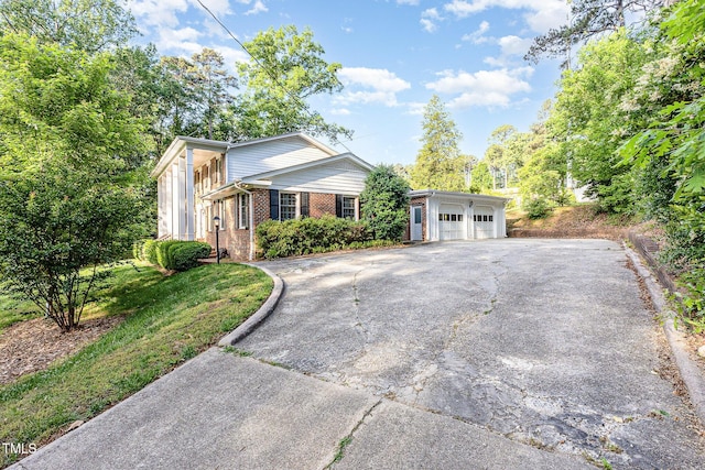 view of front of property featuring brick siding, a garage, and asphalt driveway