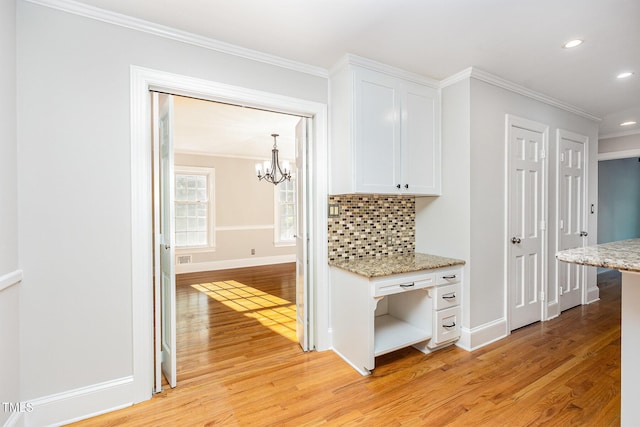 hallway with ornamental molding, light wood finished floors, a chandelier, recessed lighting, and baseboards