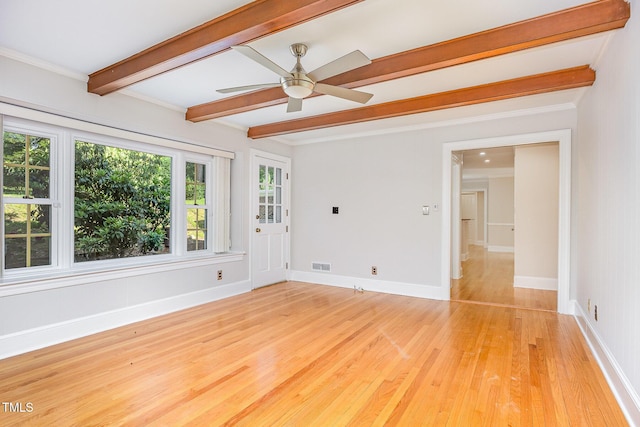 empty room featuring beamed ceiling, light wood finished floors, a ceiling fan, baseboards, and crown molding