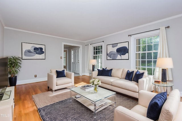 living area featuring wood finished floors, ornamental molding, and baseboards