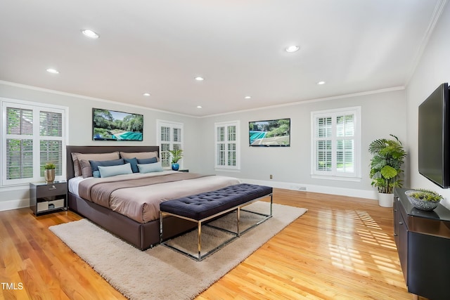 bedroom with crown molding, light wood-type flooring, recessed lighting, and baseboards