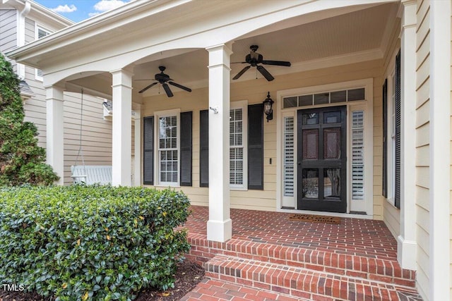 doorway to property featuring a ceiling fan and a porch
