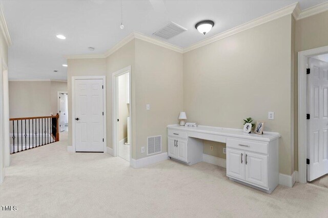 unfurnished office featuring built in desk, light carpet, ornamental molding, baseboards, and recessed lighting