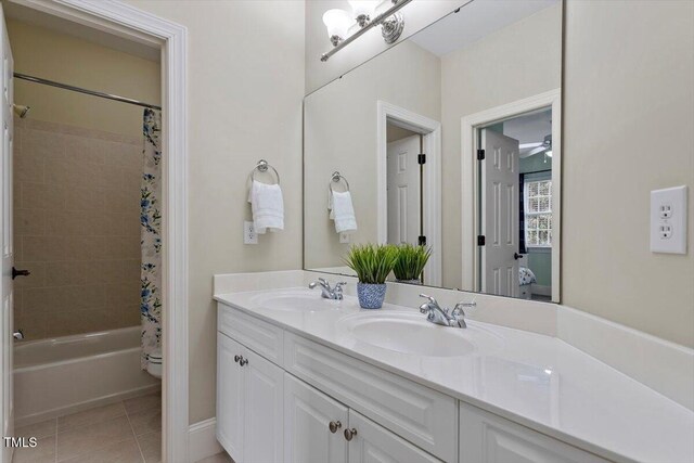 bathroom featuring tile patterned flooring, double vanity, shower / bath combo, and toilet
