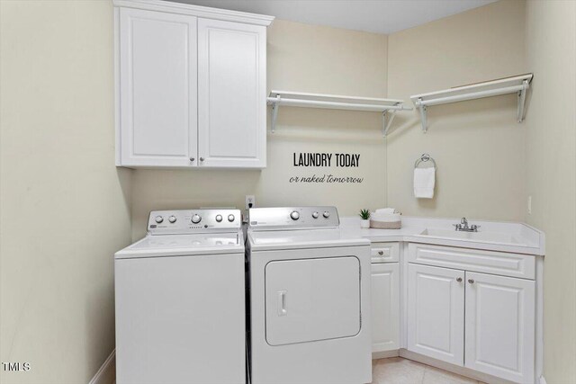 laundry area with cabinet space, independent washer and dryer, and light tile patterned floors