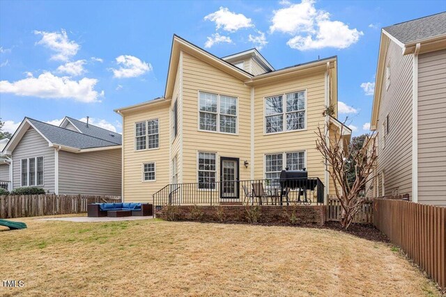 back of house featuring an outdoor living space and a patio