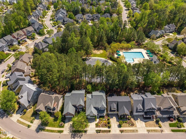 view of property location with nearby suburban area and a pool