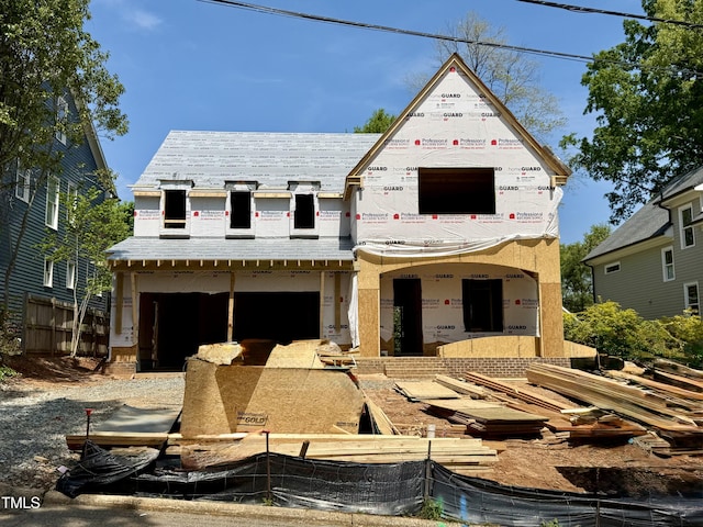 unfinished property with an attached garage and a high end roof
