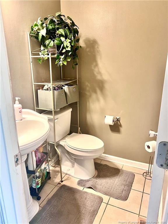 429 Bristlecone Rd, Fayetteville, NC 28311 - half bath with tile patterned flooring, toilet, and baseboards