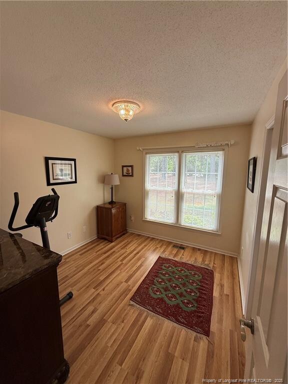 73 Night Heron Ct, Sanford, NC 27332 - office featuring a textured ceiling, light wood finished floors, and baseboards