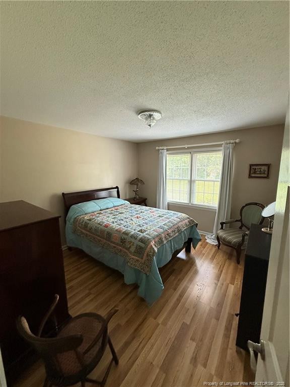 73 Night Heron Ct, Sanford, NC 27332 - bedroom with a textured ceiling and wood finished floors