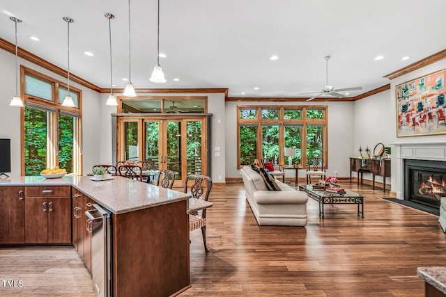 289 Stoneview, Pittsboro, NC 27312 - kitchen with ornamental molding, recessed lighting, ceiling fan, baseboards, and a fireplace with flush hearth