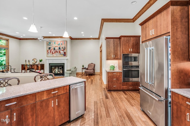 289 Stoneview, Pittsboro, NC 27312 - kitchen with stainless steel appliances, ornamental molding, a glass covered fireplace, light wood finished floors, and recessed lighting