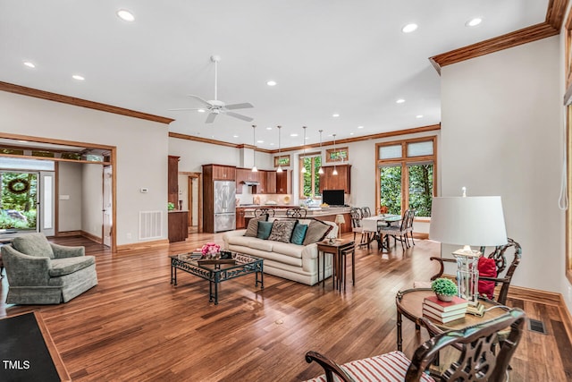 289 Stoneview, Pittsboro, NC 27312 - living room with healthy amount of natural light, recessed lighting, wood finished floors, crown molding, and baseboards