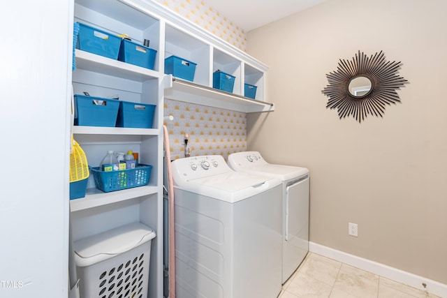 clothes washing area featuring separate washer and dryer, baseboards, and tile patterned flooring
