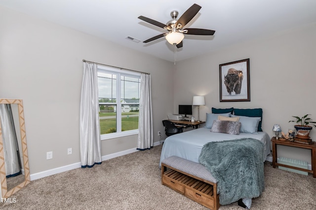 bedroom featuring light colored carpet, baseboards, and ceiling fan