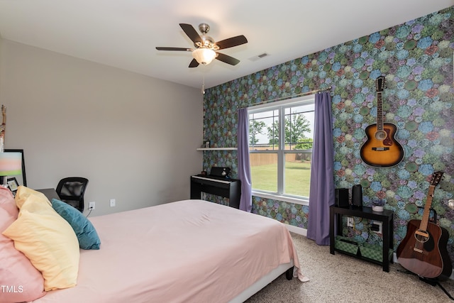bedroom with wallpapered walls, carpet flooring, and a ceiling fan