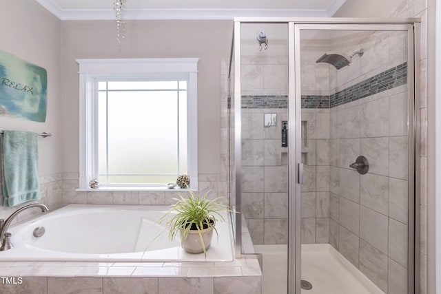 bathroom with healthy amount of natural light, a garden tub, a shower stall, and crown molding