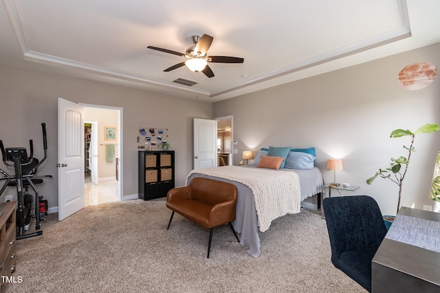 carpeted bedroom featuring a tray ceiling, a ceiling fan, and baseboards